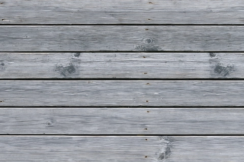 Illustration of weathered gray deck boards with darker grain and joints