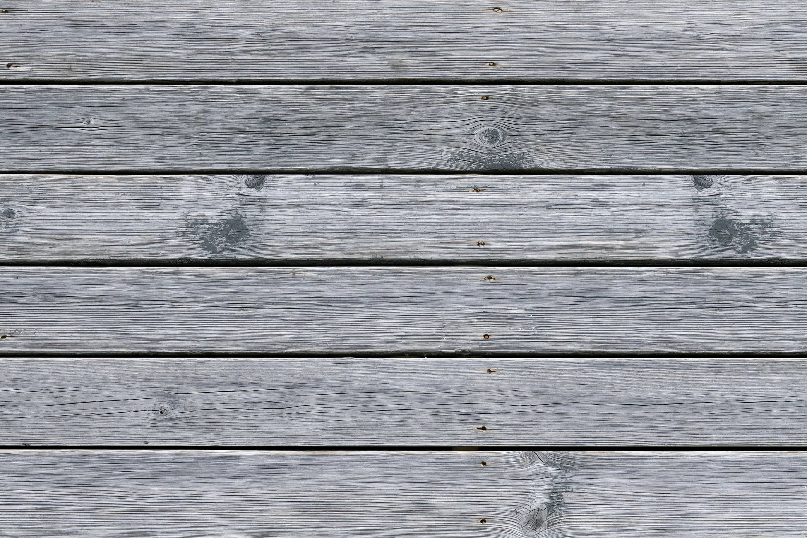 Illustration of weathered gray deck boards with darker grain and joints