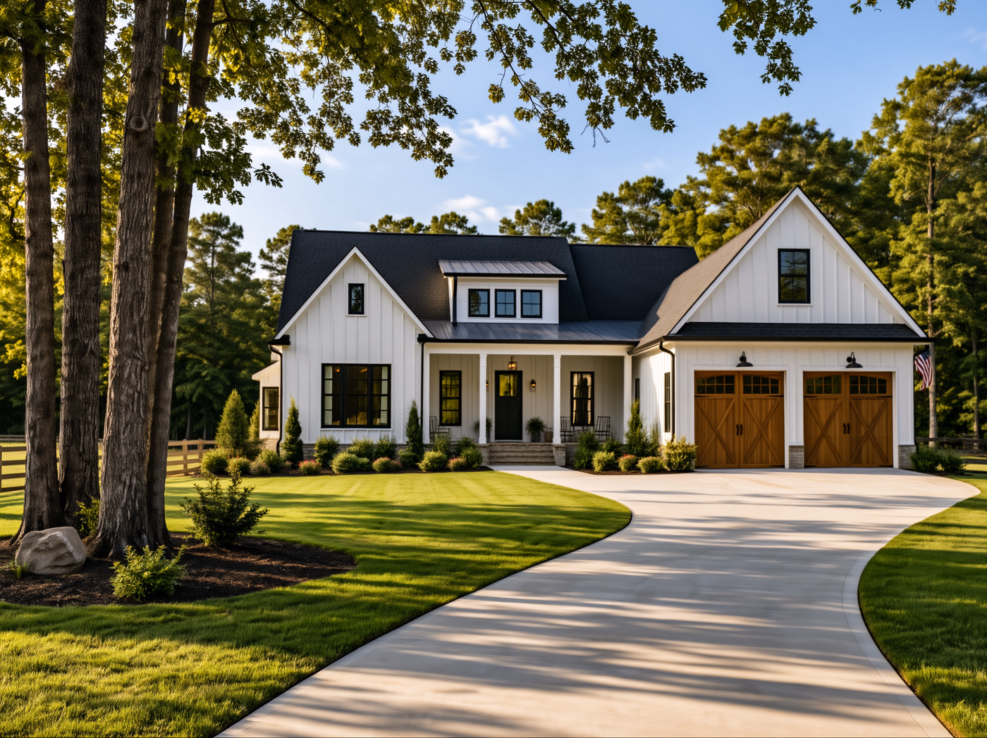 White farmhouse-style home with a central dormer, right garage and curving driveway